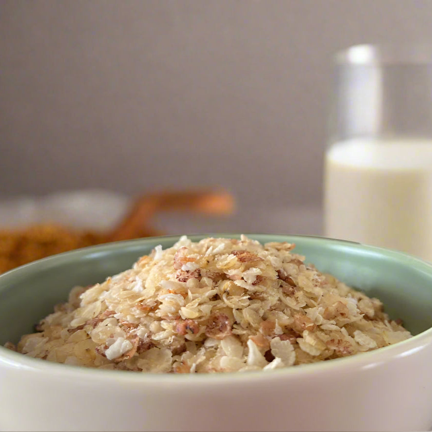 Bowl of cereal with a bottle of milk 