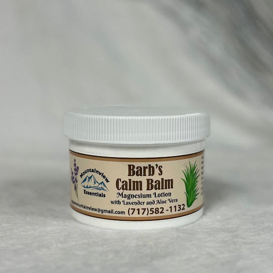 Jar of 'Barb's Calm Balm' on a gray background