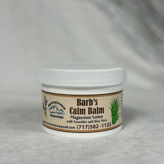 Jar of 'Barb's Calm Balm' on a gray background
